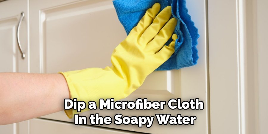 Dip a Microfiber Cloth 
In the Soapy Water